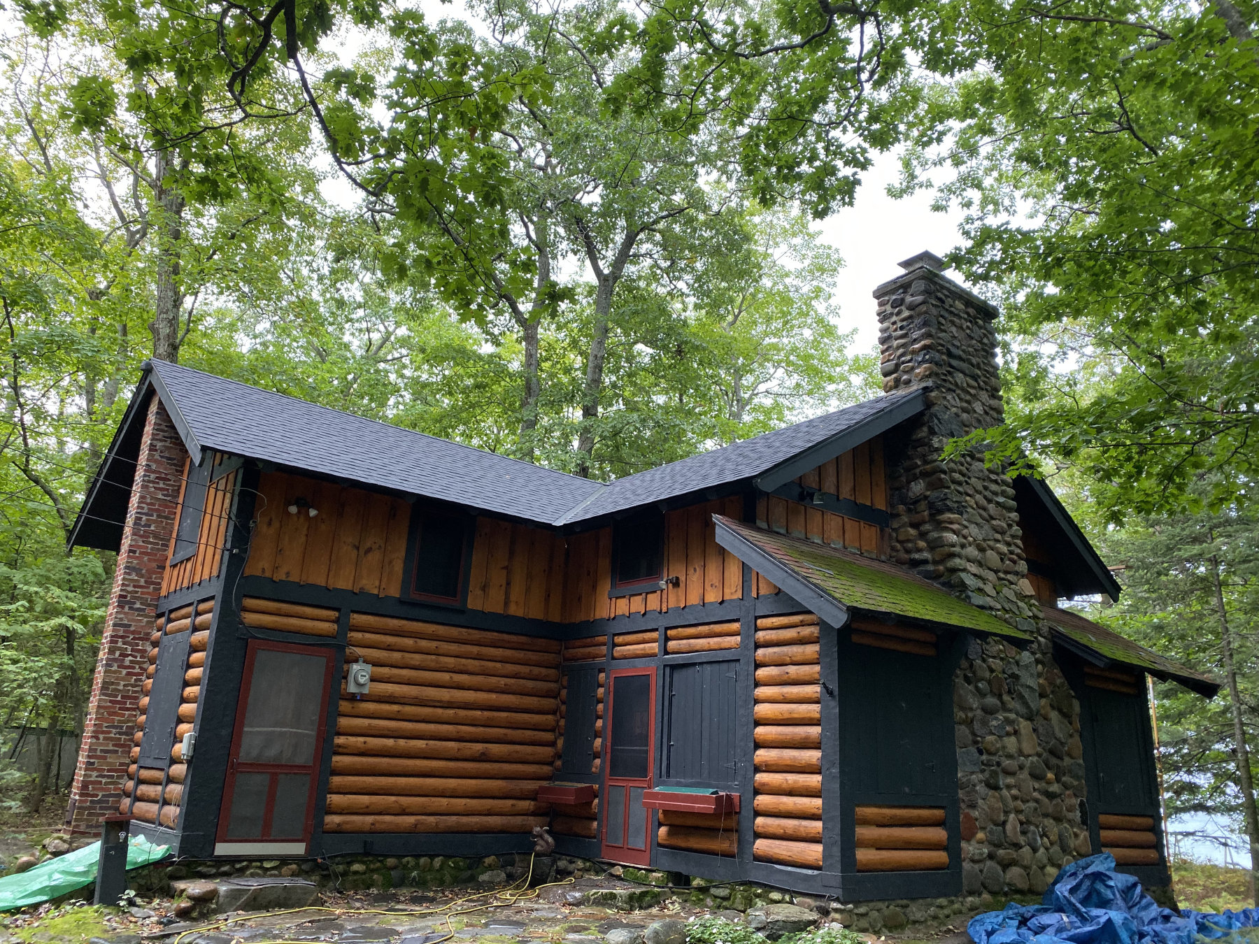 Northern Michigan log cabin with a dark shingle roof